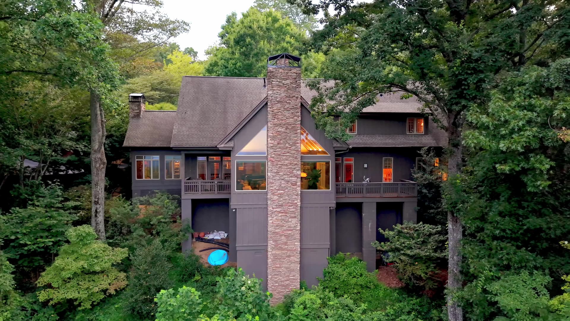 6 Eagle Rock Road at dusk, the stone chimney and the garden from above