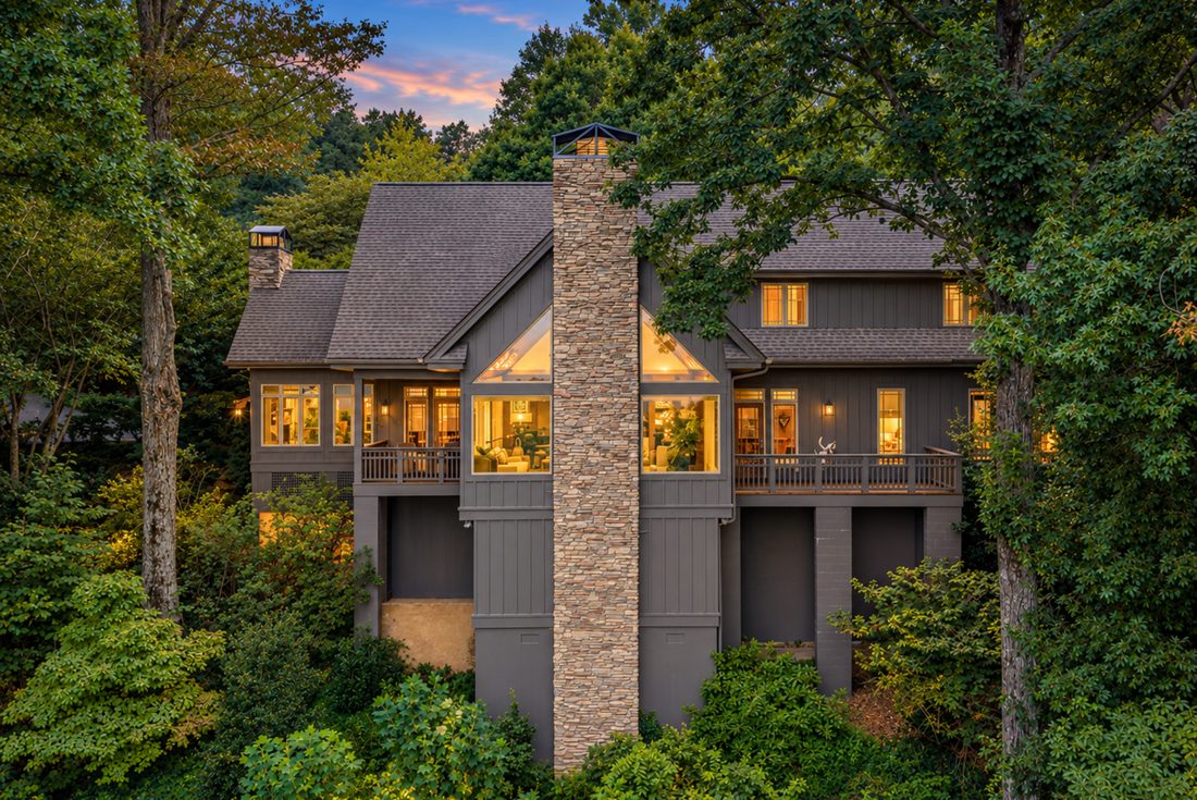 Front elevation at dusk, stone chimney